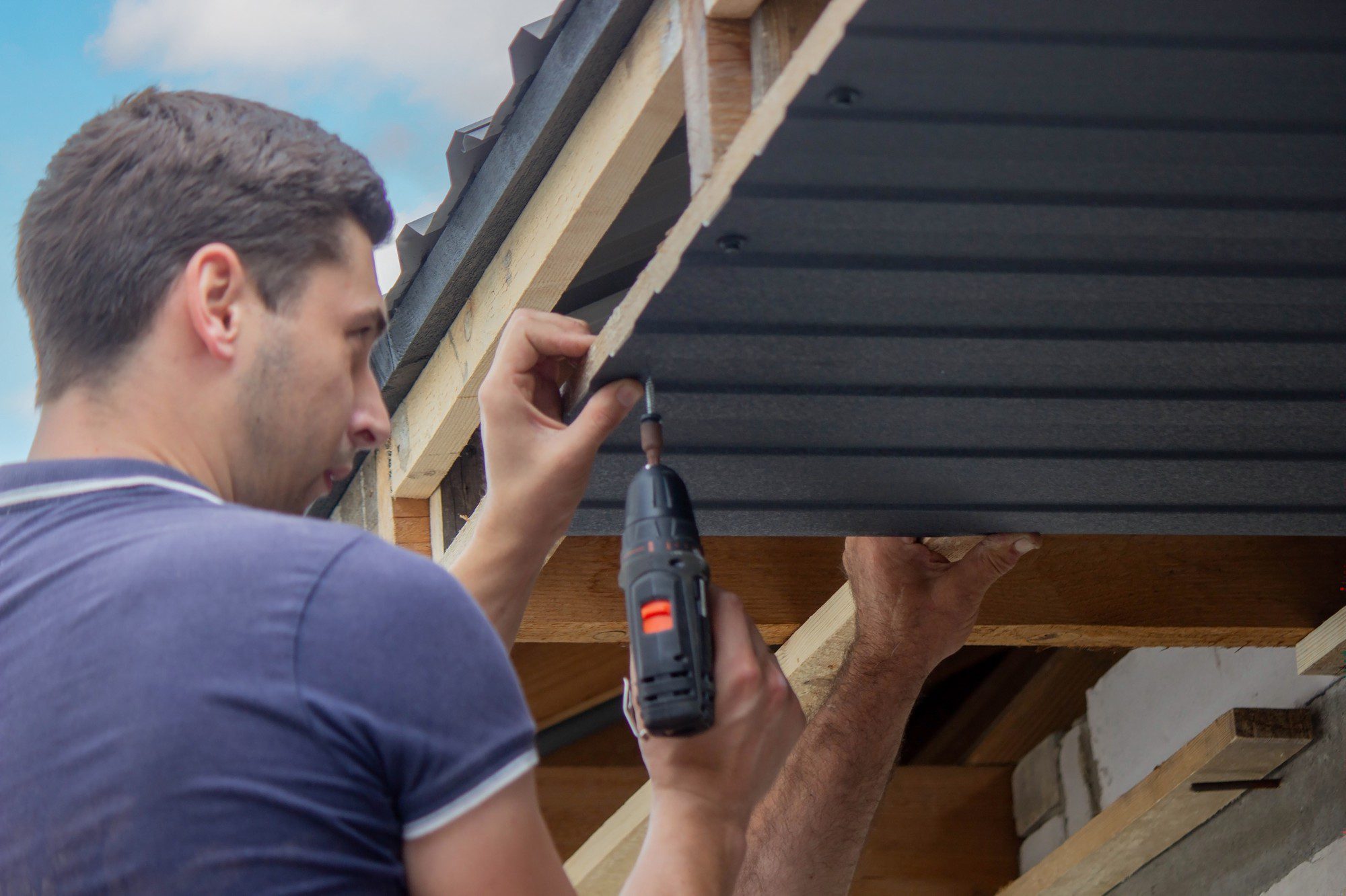 A Man Repairs The Roof Tightens The Self Tapping 2023 07 14 06 27 59 Utc